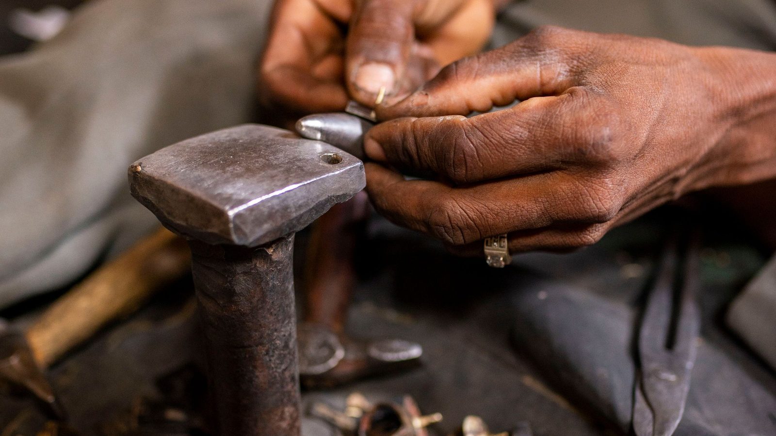 Goldschmied bearbeitet einen Ring mit dem Hammer am Amboss — Werkstatt von Juwelier Fichtinger in Amstetten